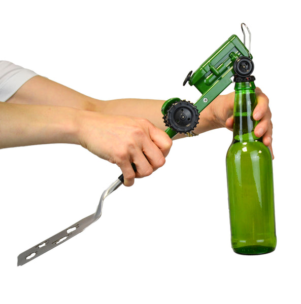 The Gibson Tractor BBQ Spatula is shown in green with the bottle opener feature, opening a green glass bottle of soda.