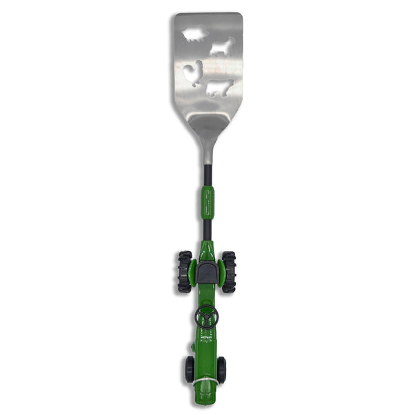 The Gibson Tractor BBQ Spatula features a detailed green farm tractor handle, bottle opener, hanging hook, and livestock themed die cuts in the stainless steel spatula blade. BBQ tools, barbeque tool, spatula, tractor spatula.